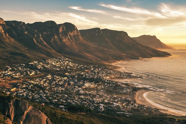 Aerial shot of the coastal suburb of Camps Bay in Cape Town South Africa at sunset