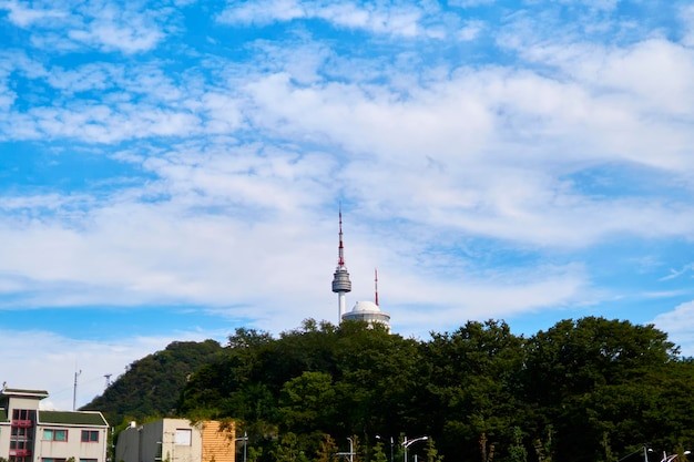 Low angle view of communications tower against cloudy sky
