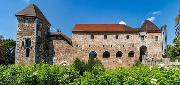 Panoramic view of the exterior facade of the medieval castle of Ljubljana with its towers and windows on a sunny day Slovenia