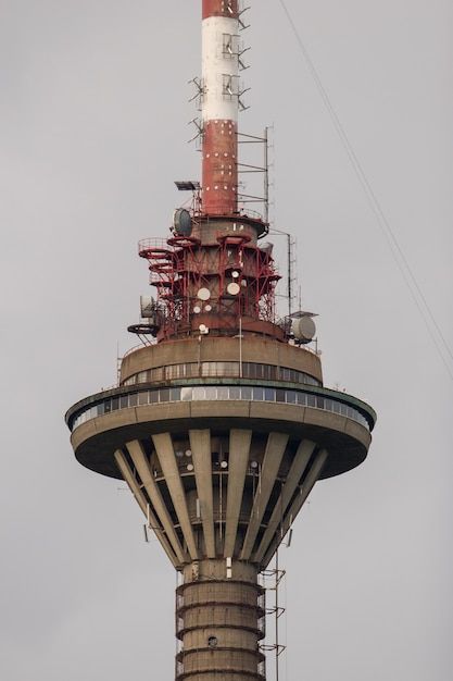 TV tower in the city of Tallinn against the gray sky with many antennas and transmitters
