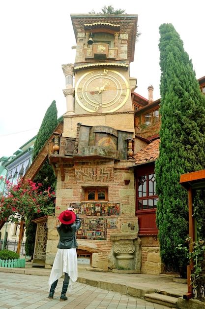 Female Taking Photos of the Leaning Clock Tower in Old City of Tbilisi Georgia