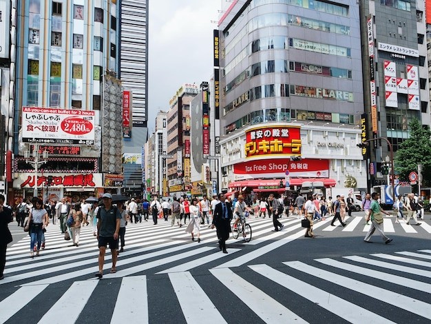 People walking on street against building in city