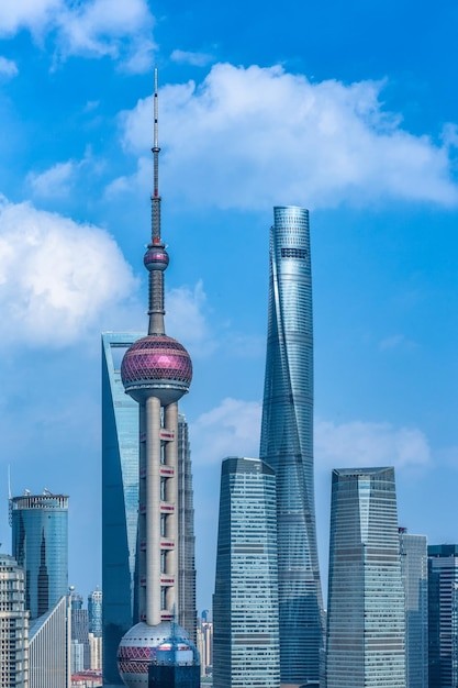 Low angle view of buildings in city against cloudy sky