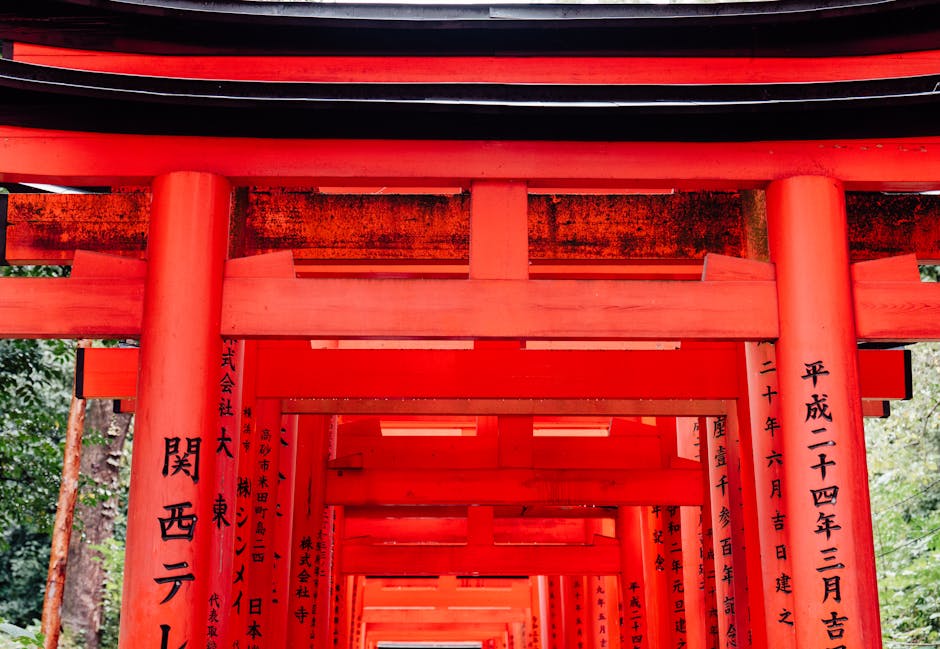 Explore the vibrant red Torii gates of Fushimi Inari Taisha in Kyoto, Japan, an iconic cultural landmark.