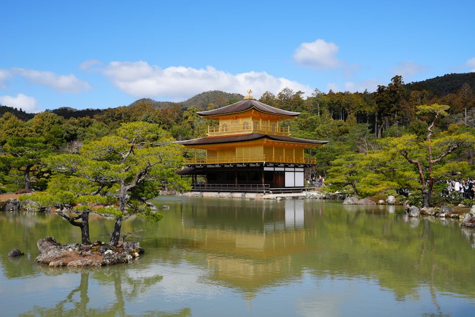 Stunning view of Kinkaku-ji Temple in Kyoto, Japan, reflecting in tranquil pond surroundings.