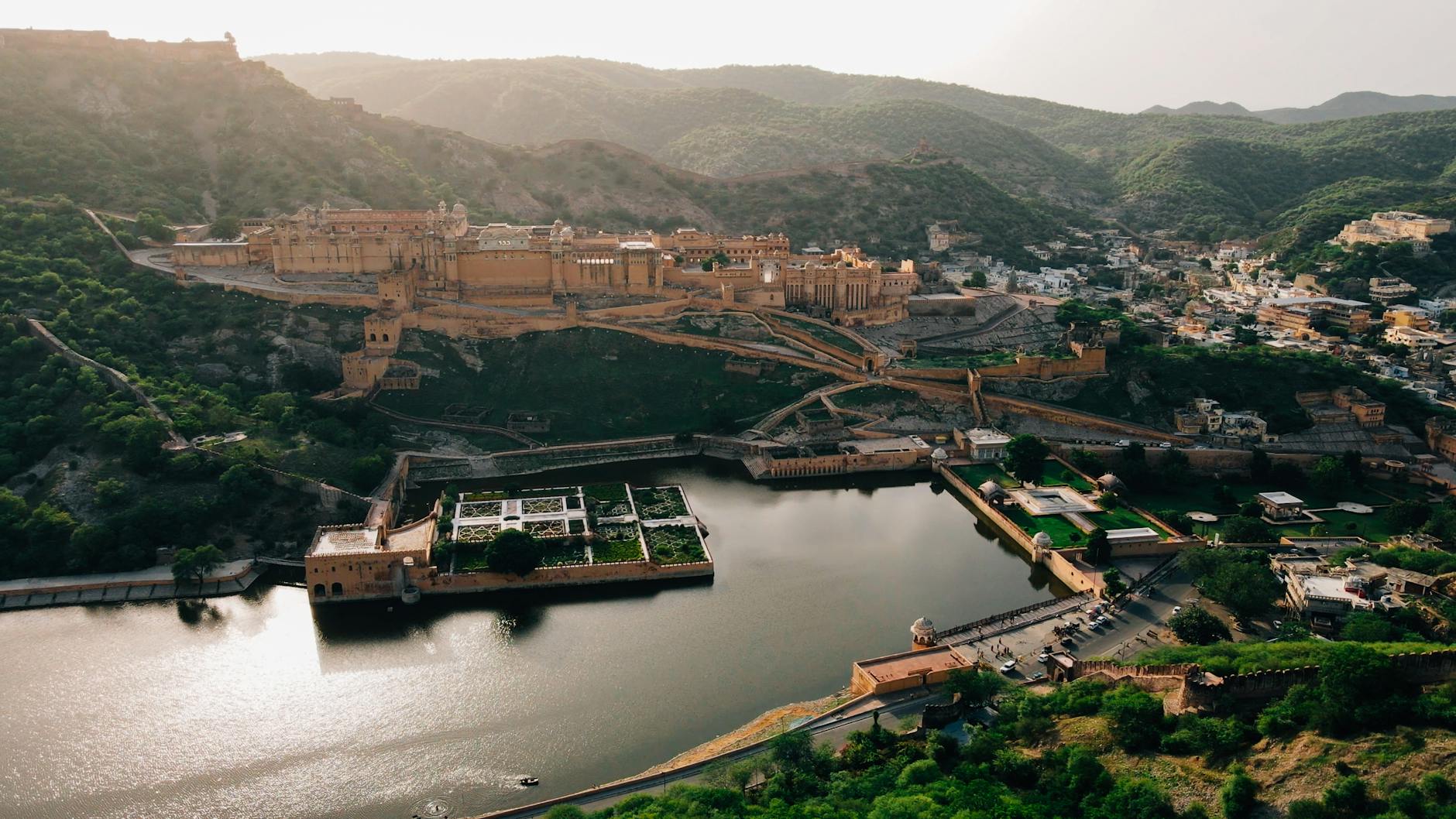 A breathtaking aerial view of Amber Fort, Jaipur with Maota Lake and scenic surroundings.