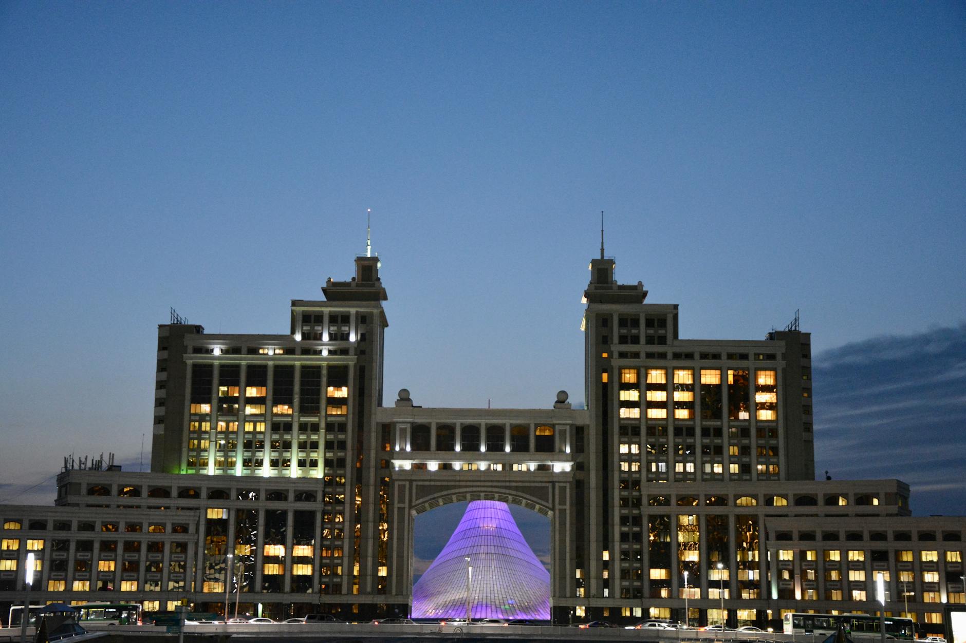 Majestic view of Astana's iconic architecture glowing against evening sky.