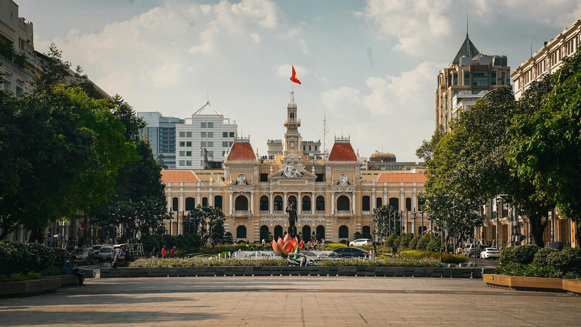 Stunning view of the historic Ho Chi Minh City Hall surrounded by lush greenery and modern architecture.