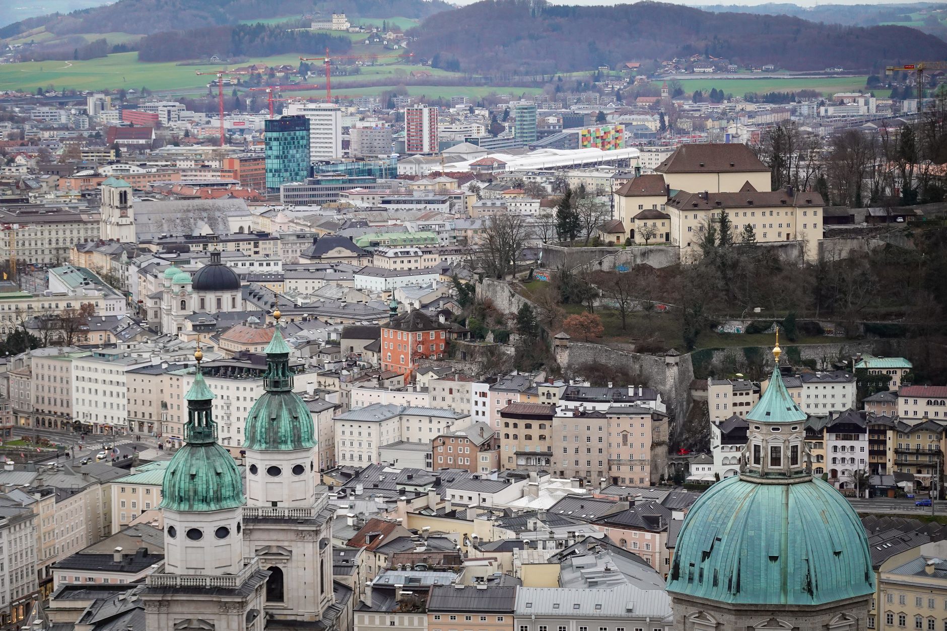 Captivating aerial view of Salzburg's historic and modern skyline with iconic architecture.
