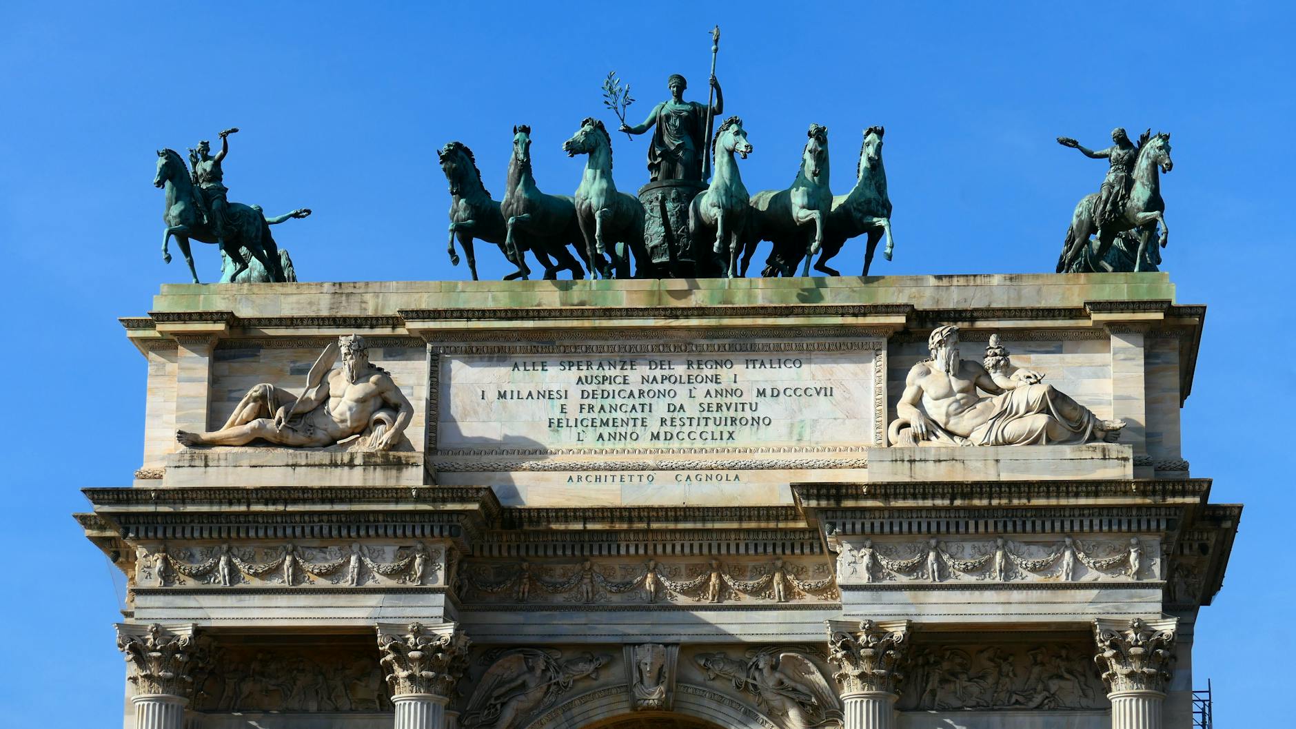 The stunning Arco della Pace in Milan, Italy, under a clear blue sky.