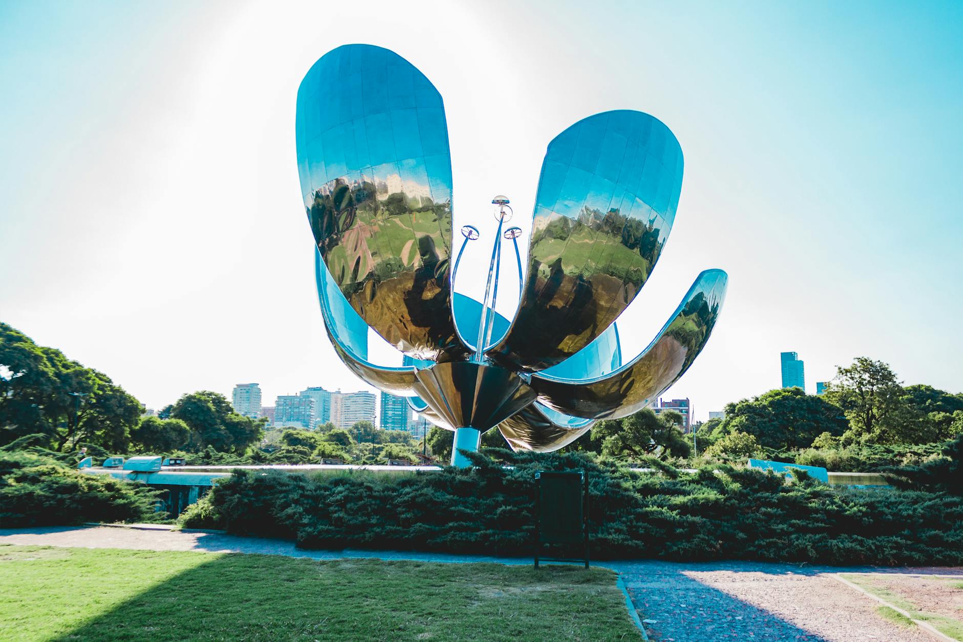 View of the Floralis Genérica sculpture in a sunny park setting in Buenos Aires, Argentina.