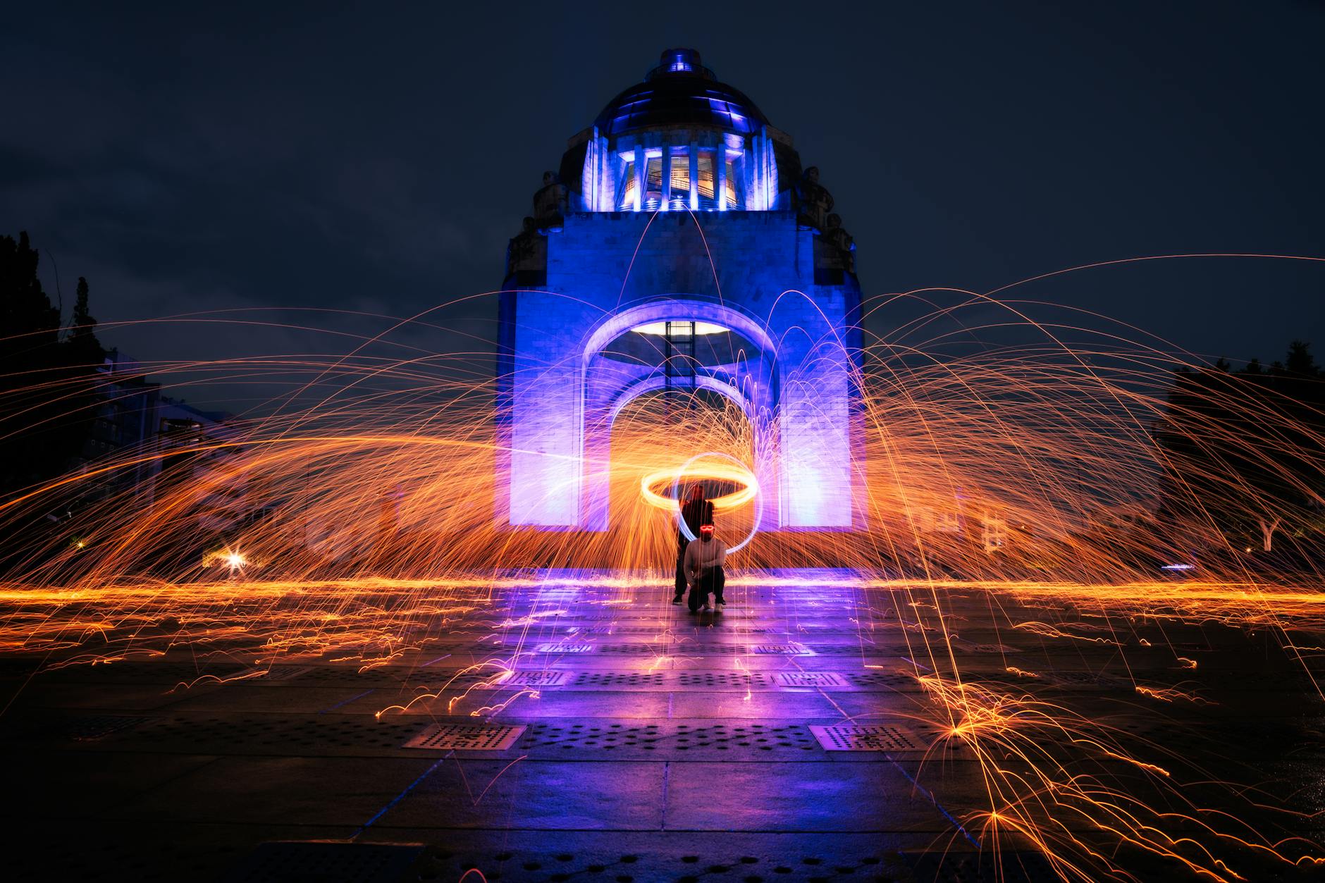 Dynamic light painting at the Monument to the Revolution in Mexico City during the night.