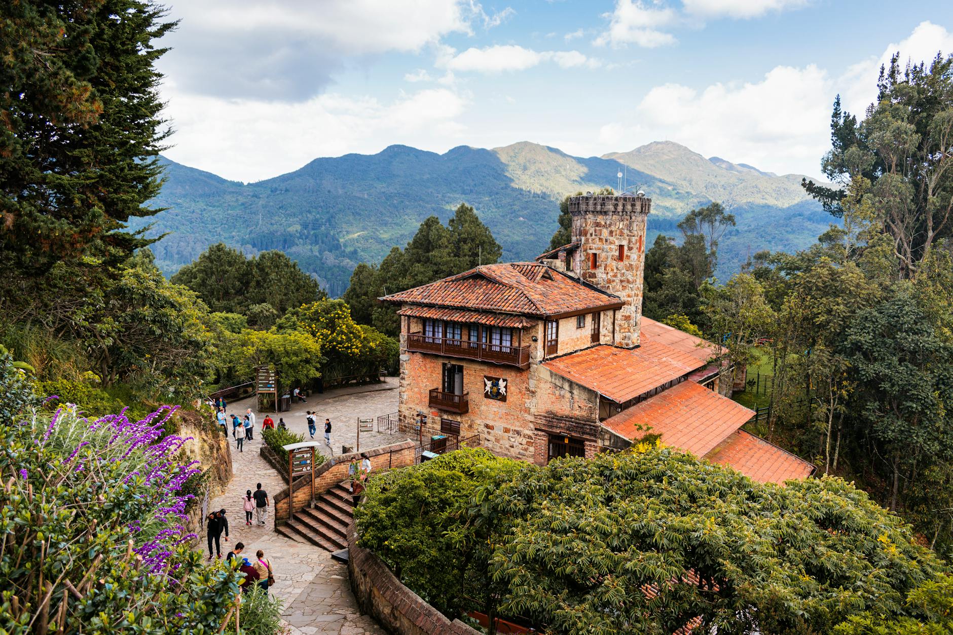 Charming stone building amidst lush greenery on Monserrate Hill, Bogotá, Colombia.