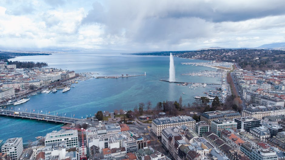 Stunning aerial view of Lake Geneva with Jet d'Eau and surrounding cityscape in Geneva, Switzerland.