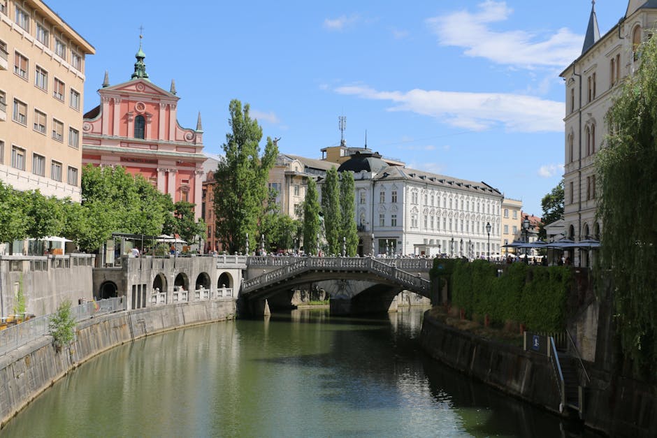 Scenic view of the Franciscan Church and Triple Bridge over the Ljubljanica River in Ljubljana, Slovenia.