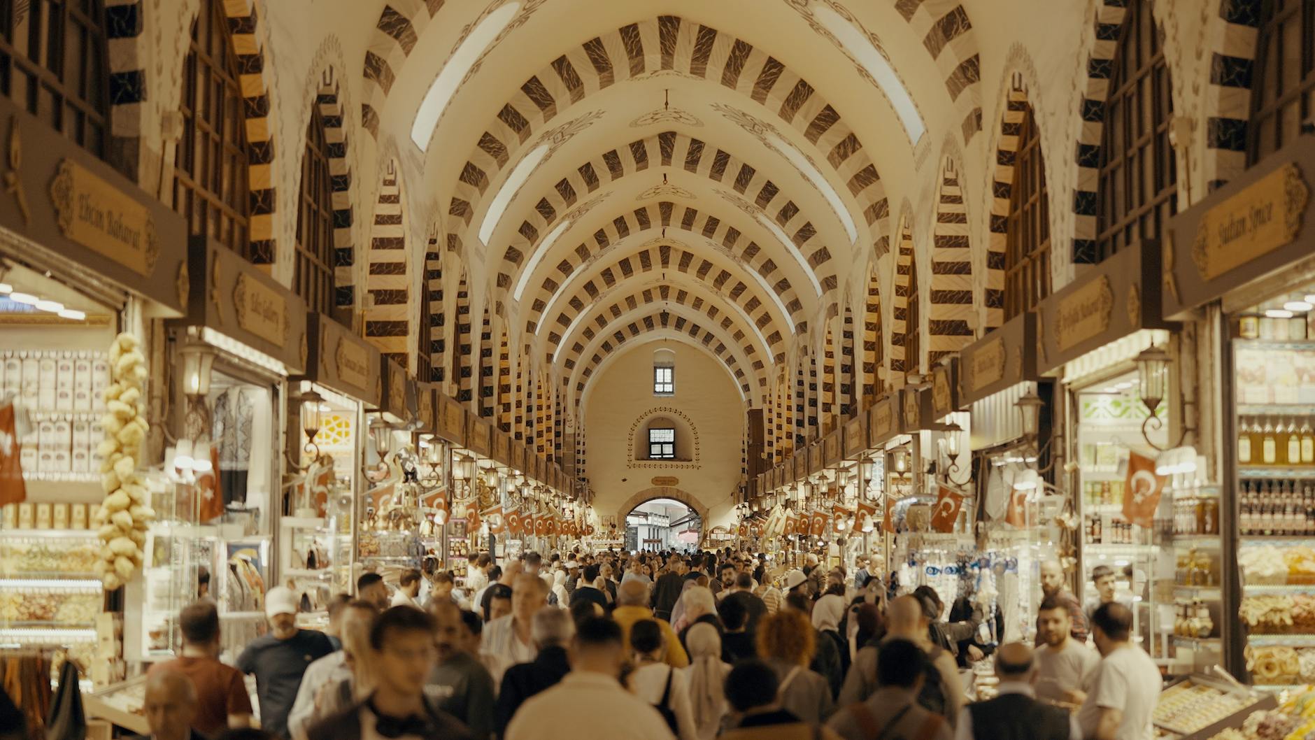 Crowds exploring the vibrant Grand Bazaar in Istanbul, showcasing traditional architecture and bustling market life.