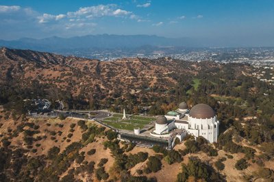 A stunning aerial shot showcasing Griffith Observatory overlooking Los Angeles and the surrounding mountains.