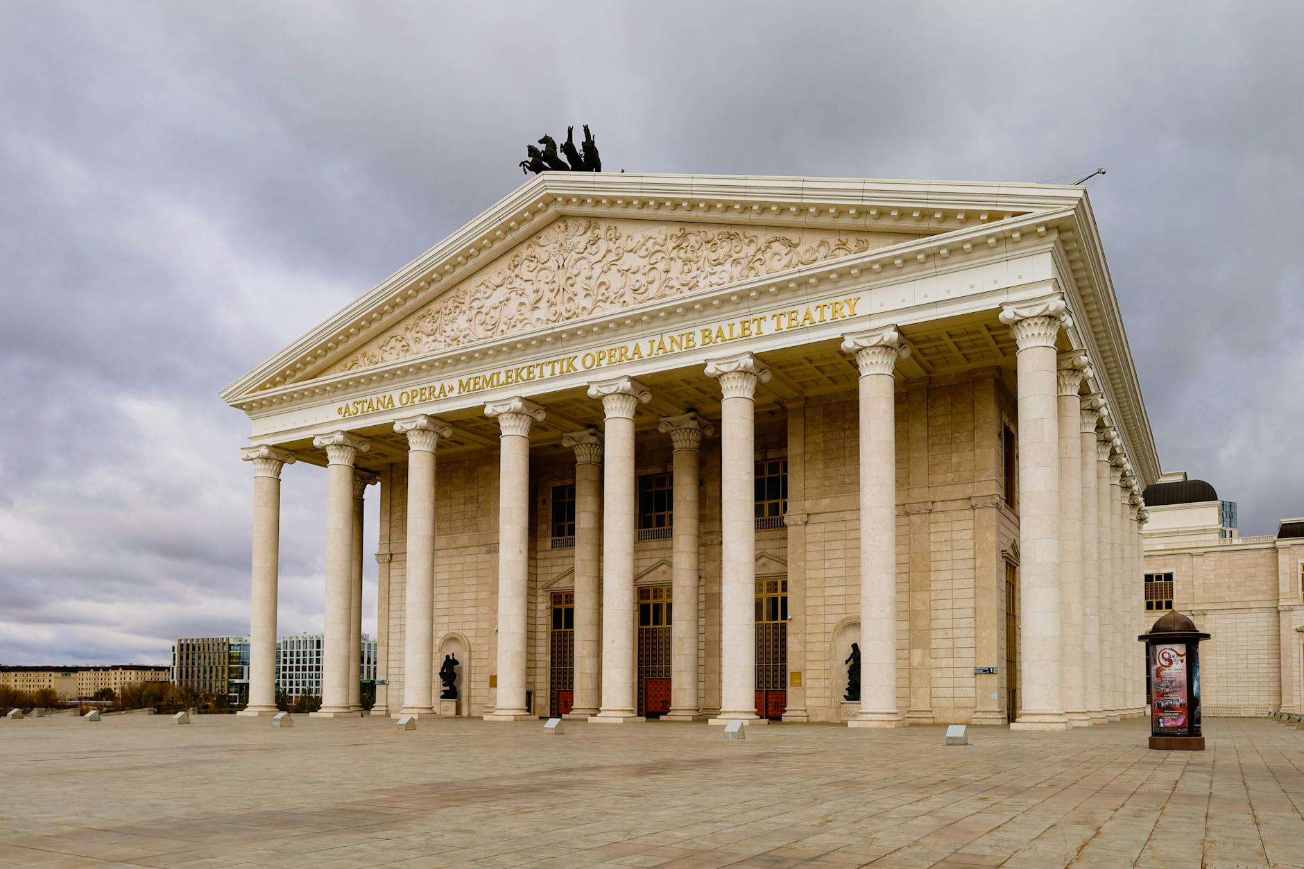 Astana Opera House facade with columns under a moody sky, showcasing neoclassical architecture.