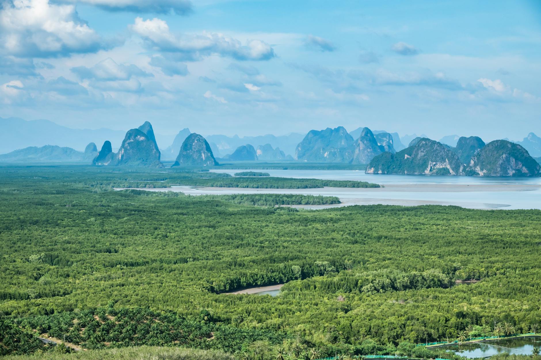 Breathtaking aerial view of Phang Nga Bay's lush landscapes and majestic limestone cliffs in Phuket, Thailand.
