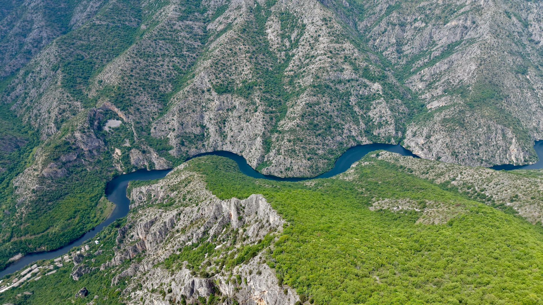 Stunning aerial photo of Matka Canyon's winding river and lush greenery in North Macedonia.