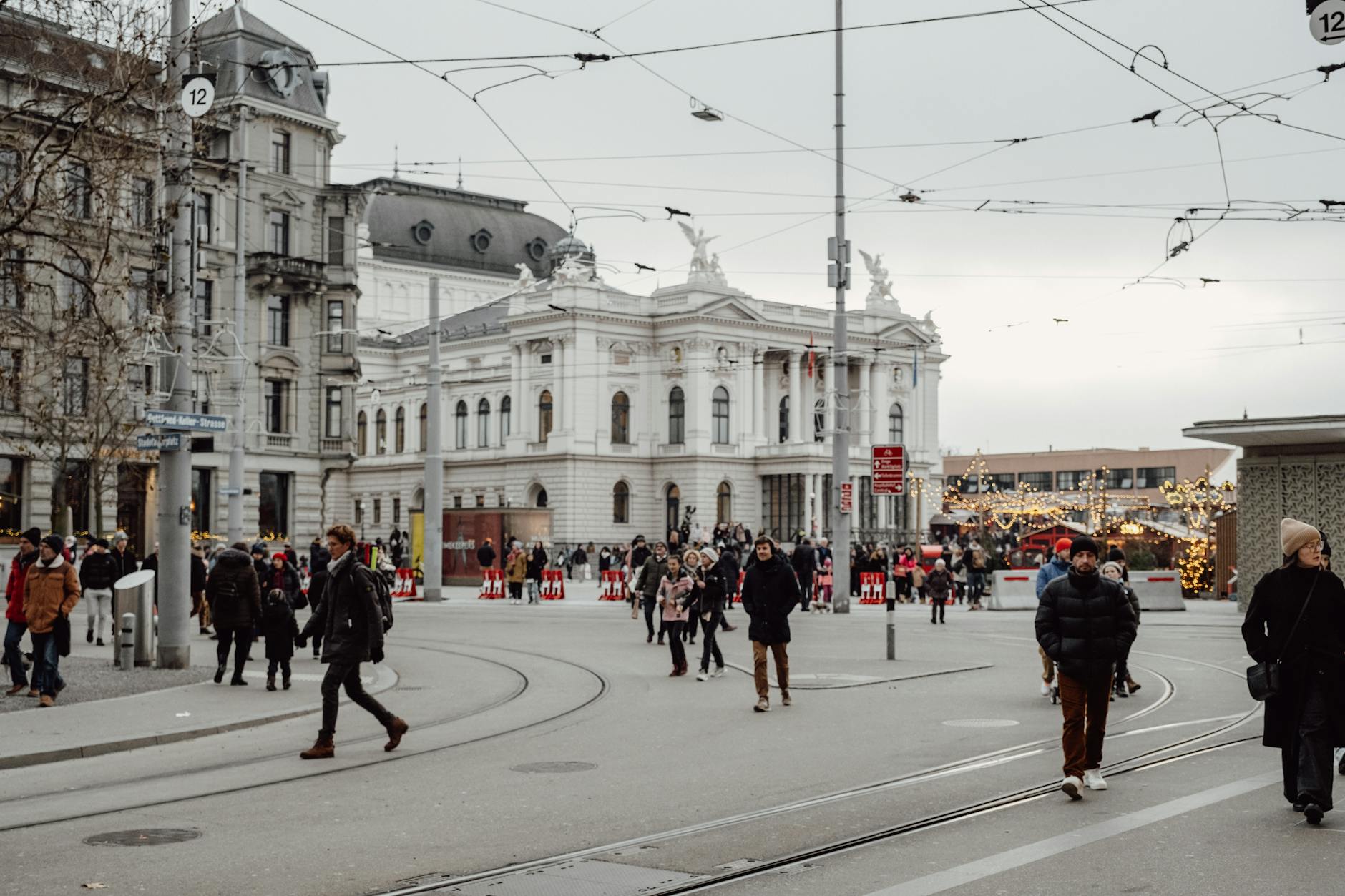 Explore the lively streets of Zurich, Switzerland, featuring historic architecture and bustling holiday crowds.