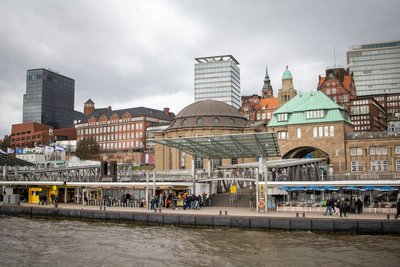 A vibrant scene at Hamburg's iconic Landungsbrücken with historic and modern architecture.