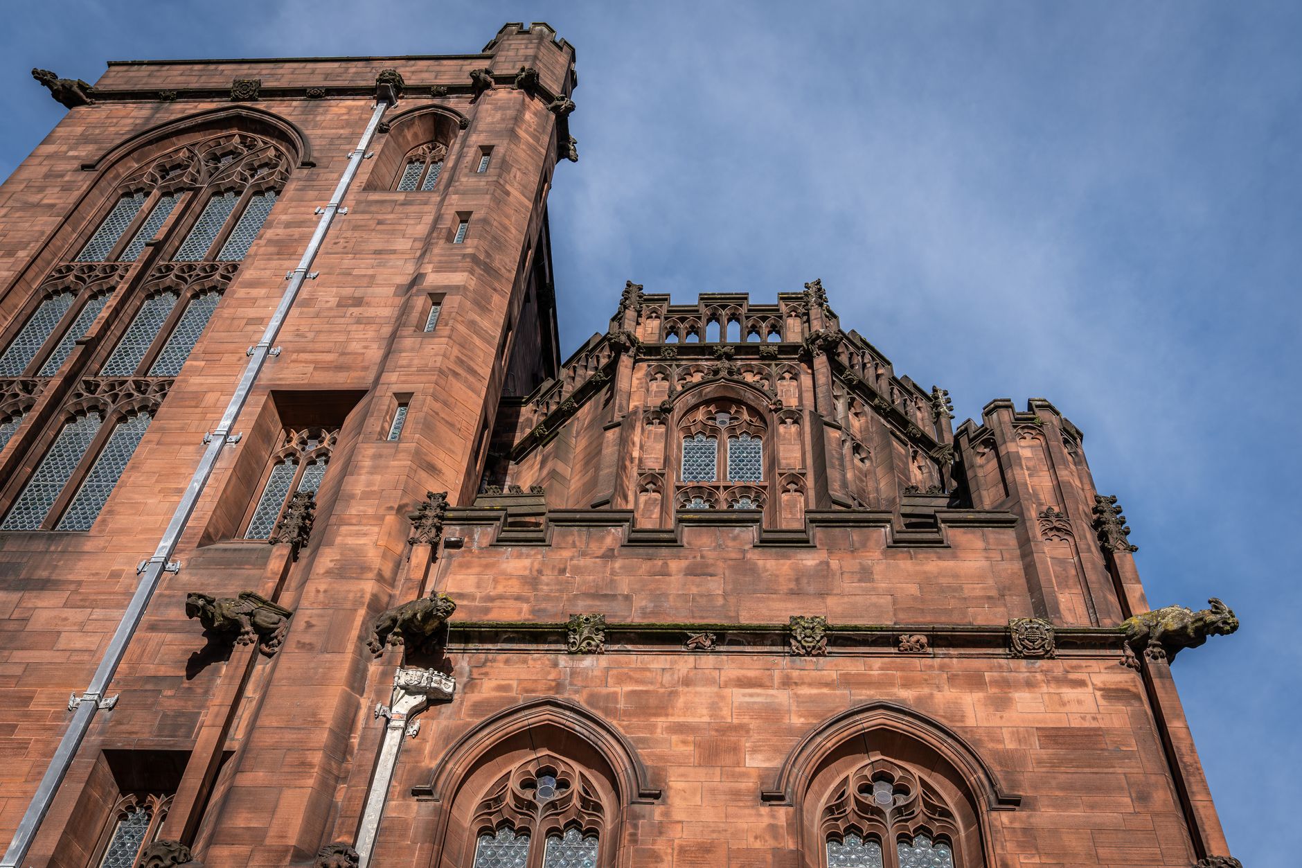 Detailed view of the Gothic architecture of Manchester Cathedral, emphasizing its intricate stonework and historic design.