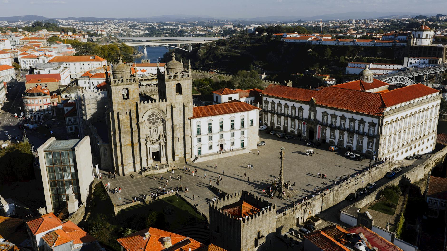 A stunning aerial shot of Porto's historic Sé Cathedral and surrounding areas at sunset.