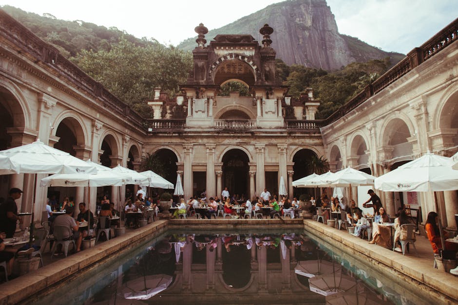 Scenic courtyard dining spot at Parque Lage, surrounded by stunning architecture and mountainous backdrop.