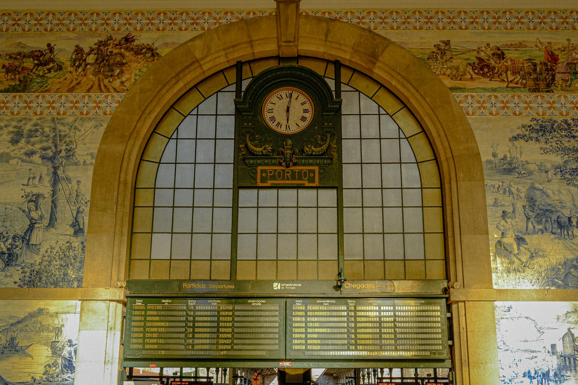 Beautiful detail of São Bento Station's iconic clock and blue azulejos in Porto, Portugal.