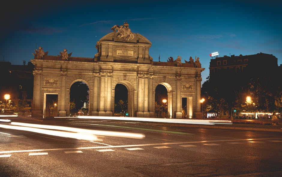 Long exposure of Puerta de Alcalá illuminated at night in Madrid, Spain.
