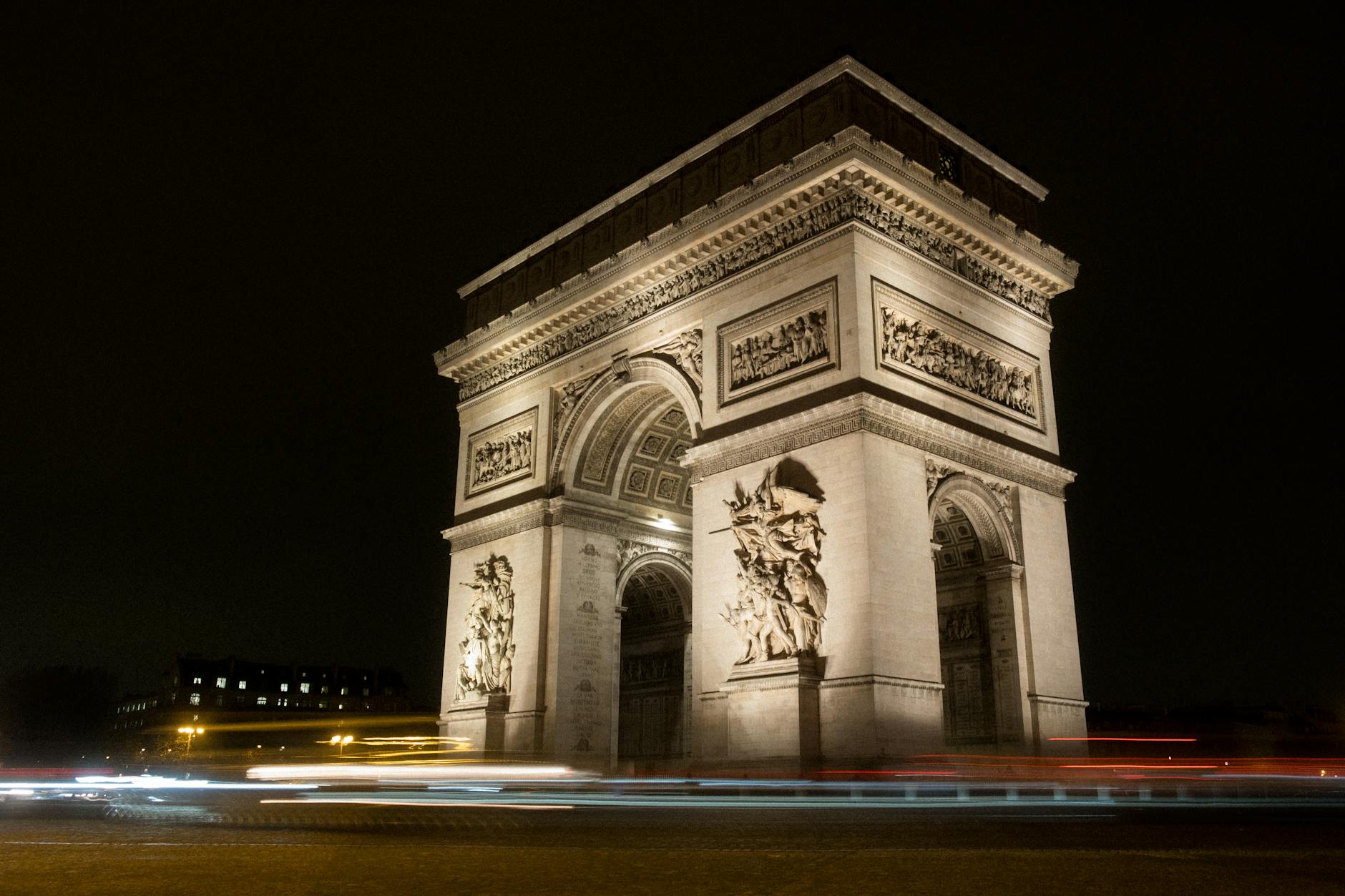 Elegant dusk capture of the illuminated Arc de Triomphe in Paris, France at night.