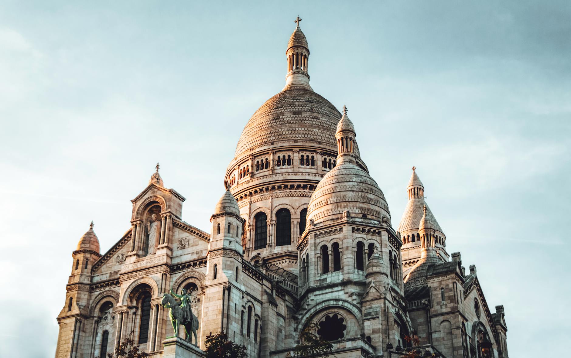 Low angle shot of the iconic Sacré-Cœur Basilica in Paris, showcasing its beautiful architecture.