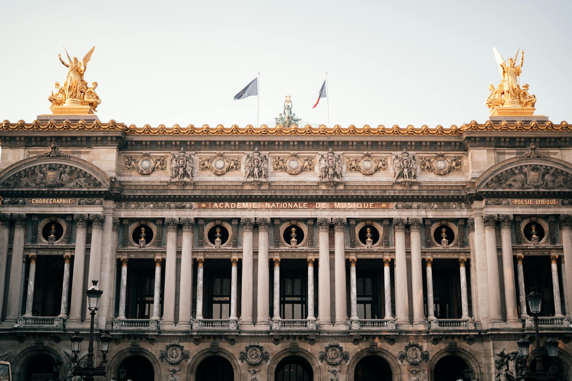 Elegant facade of Palais Garnier Opera House in Paris, France captured in daylight.