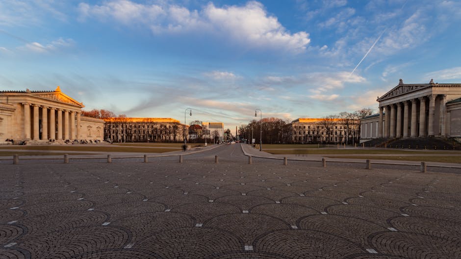 A scenic view of Königsplatz in Munich with neoclassical architecture at sunset.