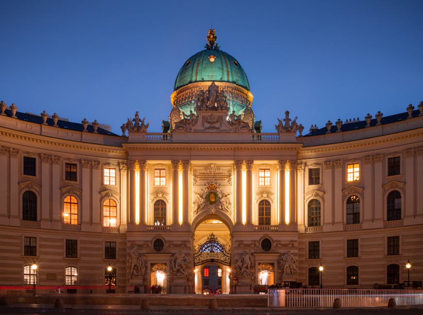 Stunning view of Hofburg Palace lit up during dusk in Vienna, Austria.