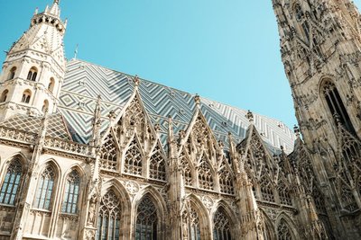 Detailed view of St. Stephen's Cathedral's Gothic architecture under clear blue sky in Vienna.