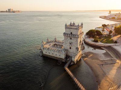 A stunning aerial view of Belém Tower in Lisbon, Portugal during sunset.
