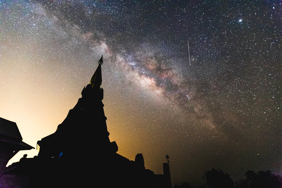 Stunning view of the Milky Way over a temple silhouette in Chiang Mai, Thailand.