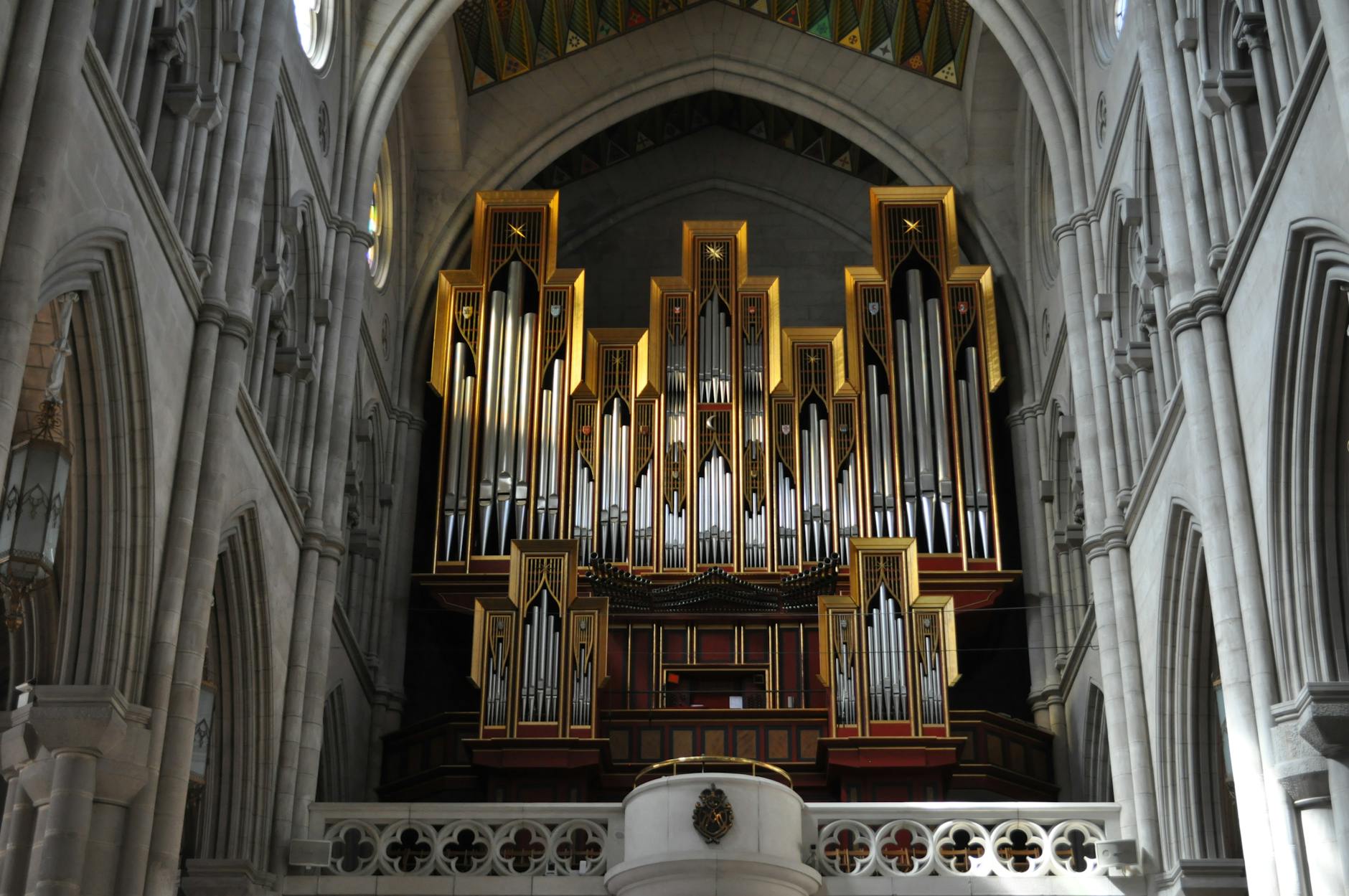 Grandiose organ in Almudena Cathedral, showcasing its intricate architecture in Madrid, Spain.