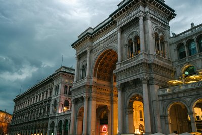 Majestic view of Galleria Vittorio Emanuele II, Milan, showcasing its historic architectural grandeur at dusk.