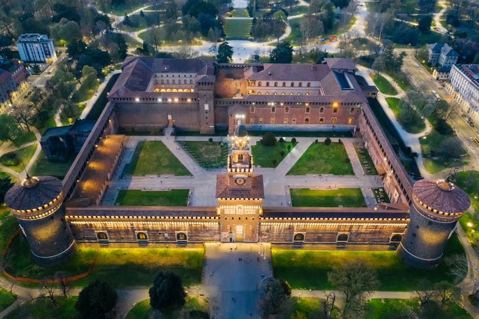 Stunning aerial shot of Sforza Castle in Milan, Italy during twilight, highlighting its architectural beauty.