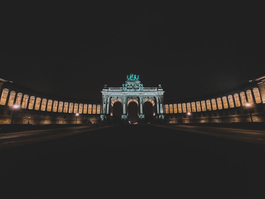 Illuminated Triumphal Arch at night in Parc du Cinquantenaire, Brussels, Belgium.