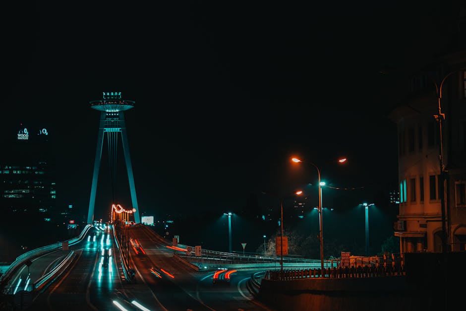 Discover the stunning night view of Bratislava, showcasing the iconic SNP Bridge and city lights.
