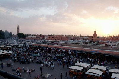Bustling Jemaa el-Fnaa in Marrakech at sunset, showcasing a lively market scene.