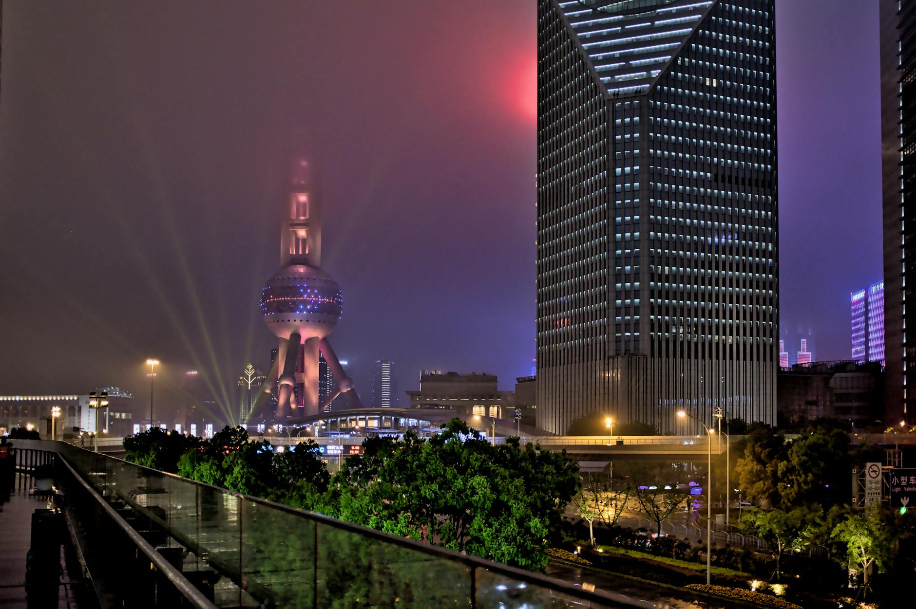 Vibrant Shanghai night skyline featuring Oriental Pearl Tower and modern skyscrapers.