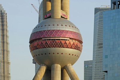 Close-up of the Oriental Pearl Tower in Shanghai, showcasing its unique design against modern skyscrapers.