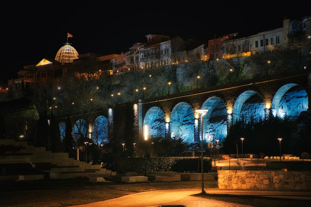 A night view of a building with arches lit up