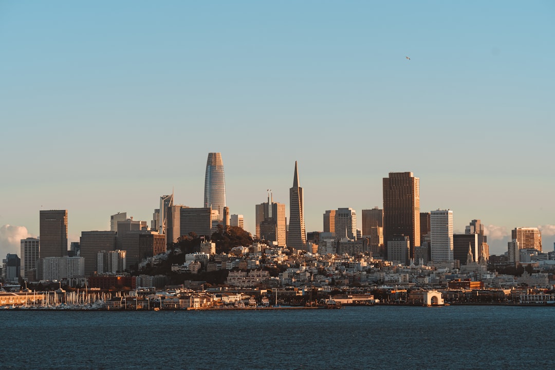 a city skyline with a body of water in the foreground