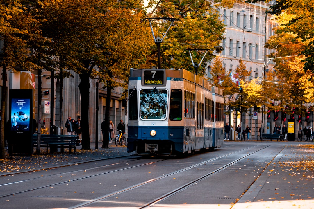 a blue and white trolley on a city street